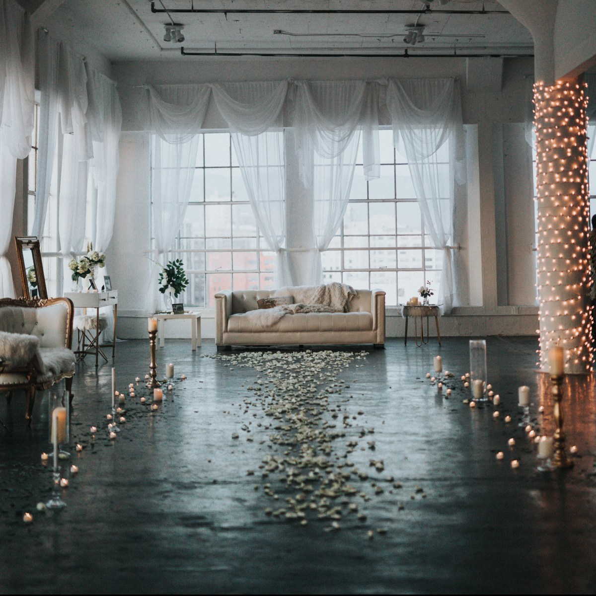 Beautiful wedding room with drapes, couch and floral aisle